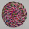 This vibrant multicolored trivet is approximately 8 inches round. 